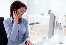 Woman on phone at computer